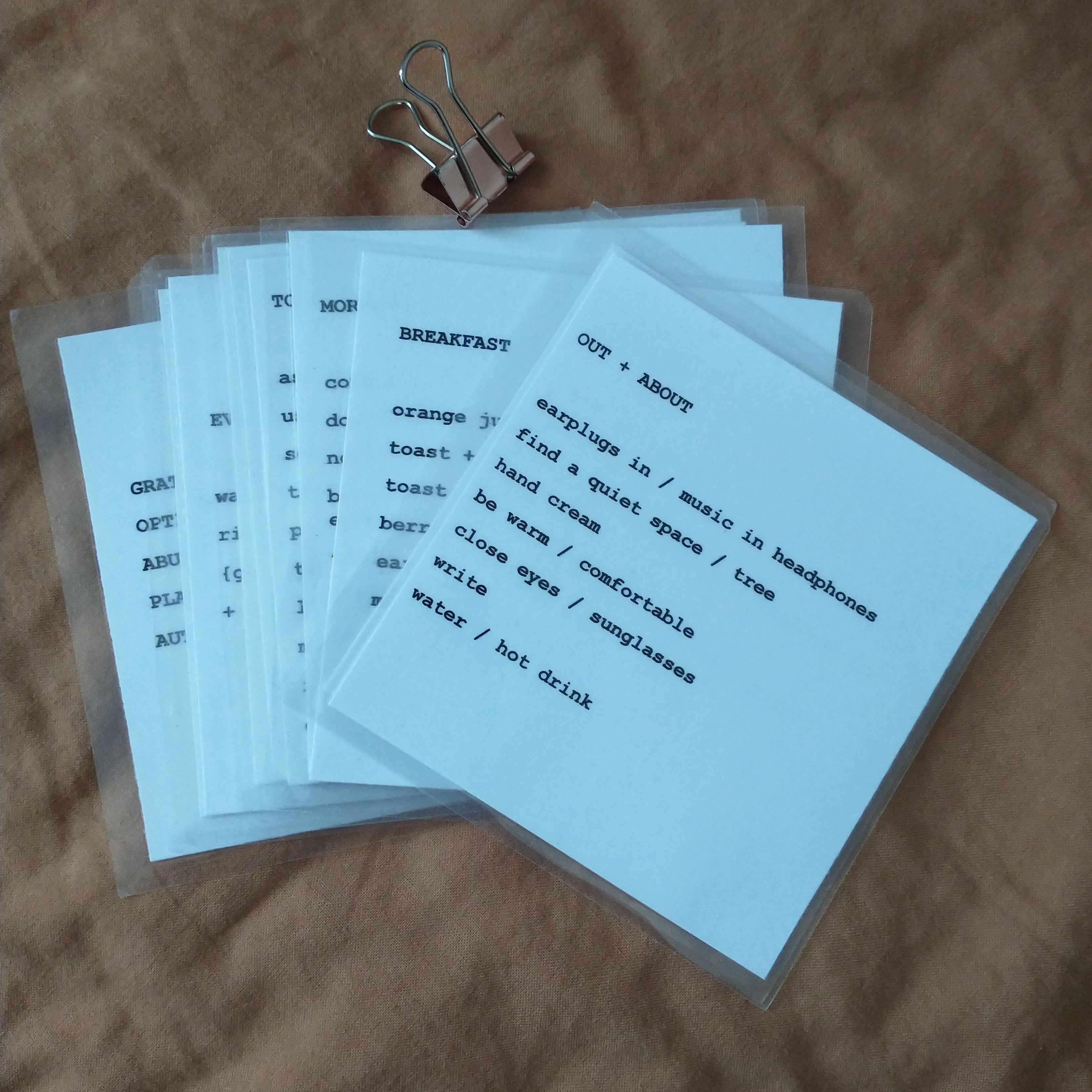 Set of small handmade self care prompt cards with typewriter text on white card